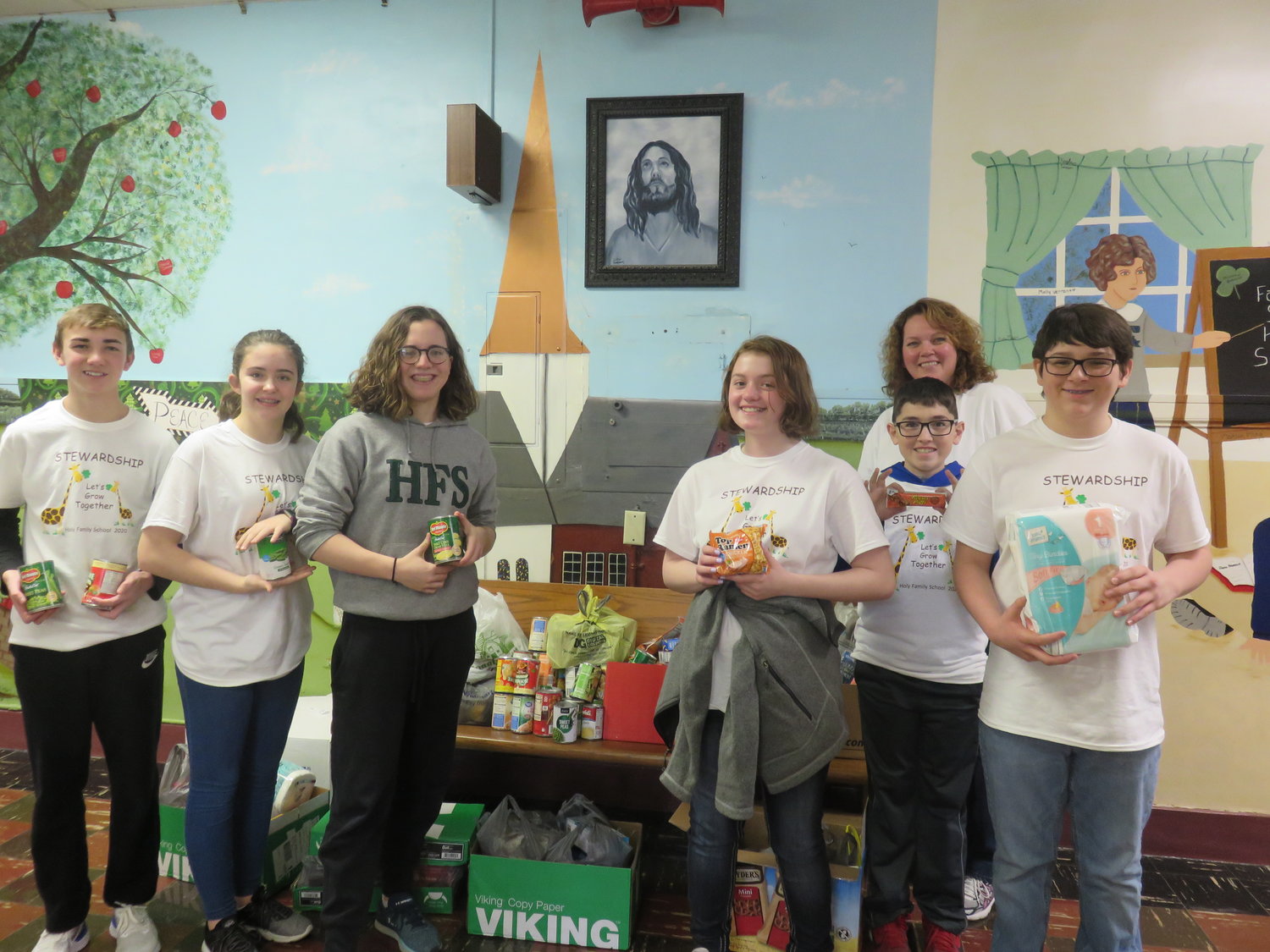 Eighth-graders gather up the items donated by students and their families for Holy Family parish's Good Neighbor Project.